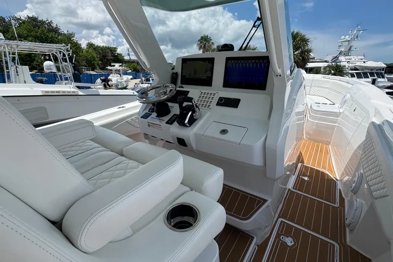 Slide: The Image of 2025 Intrepid 375 Nomad SE boat interior with modern helm and luxurious seating. - 24