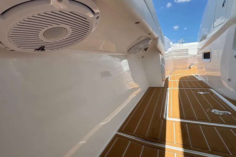 Slide: The Image of 2025 Intrepid 375 Nomad SE boat interior with teak flooring and marine speakers. - 21