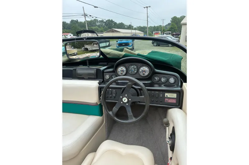 Slide: The Image of 1996 MasterCraft ProStar 190 boat dashboard with steering wheel and gauges. - 2