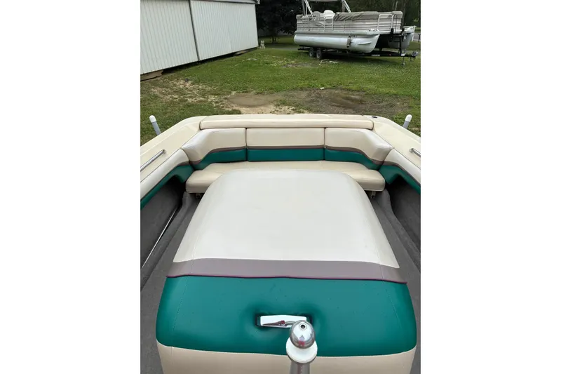 Slide: The Image of 1996 MasterCraft ProStar 190 boat interior with teal and cream seating, parked outdoors. - 5
