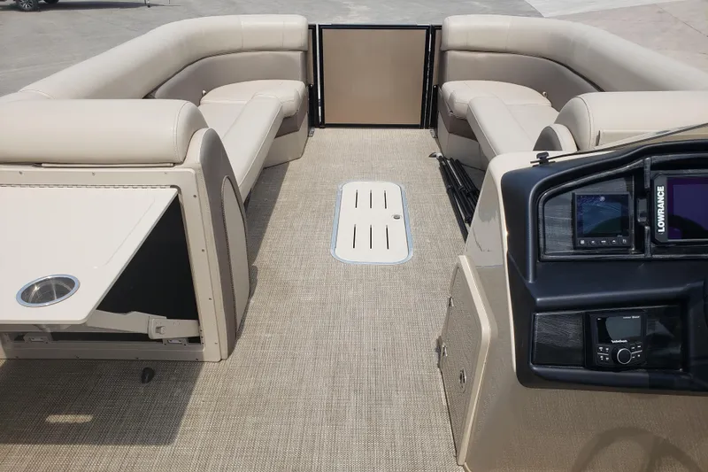 Slide: The Image of 2023 Bentley Pontoons Elite 253 Admiral interior with beige seating and modern dashboard. - 8