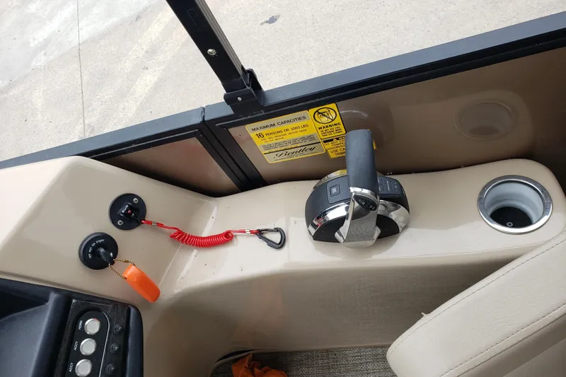 Slide: The Image of Control panel of 2023 Bentley Pontoons Elite 253 Admiral with throttle and cup holder. - 5