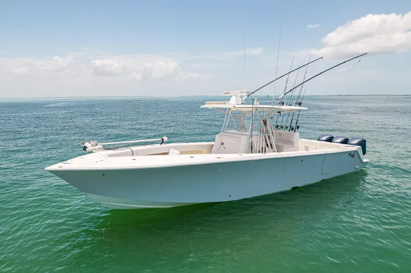 The Image of 2018 SeaVee 370Z boat on calm ocean waters, equipped with fishing rods. - 0