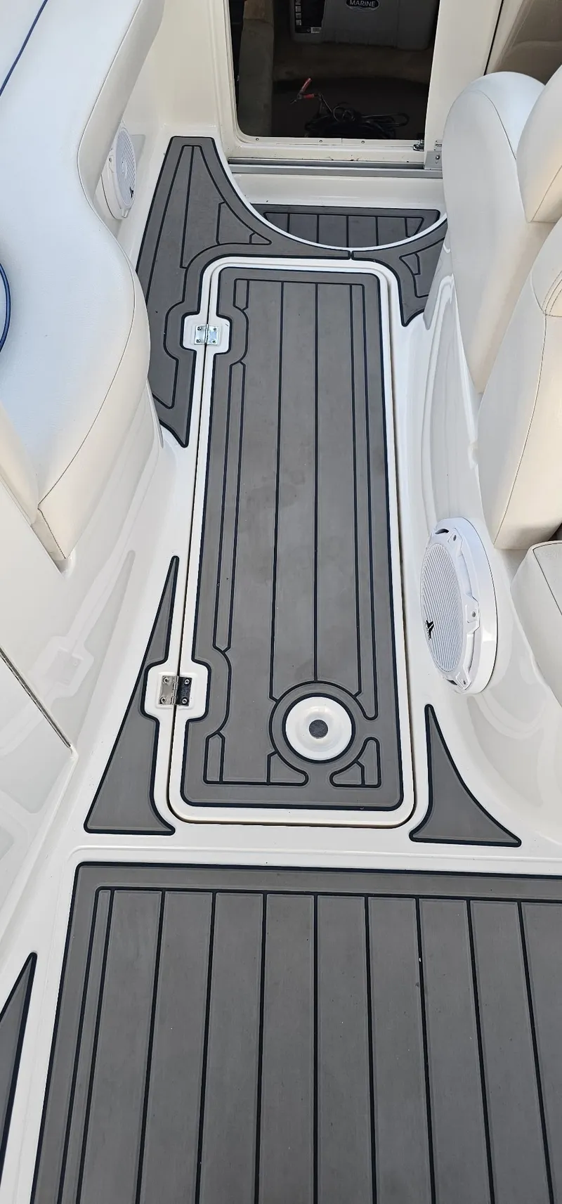 Slide: The Image of The image shows the deck area of a boat with gray and white non-slip mats. - 10