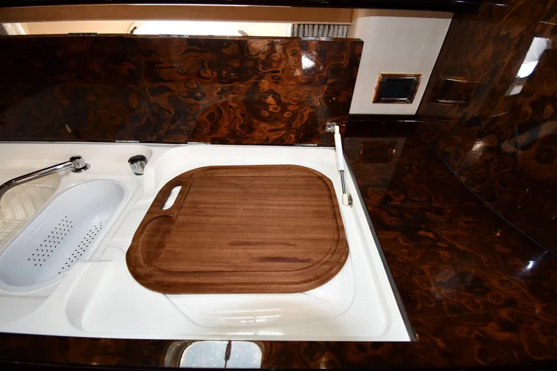 Slide: The Image of Luxurious kitchen area in 1997 Sunseeker Camargue 51 yacht with elegant wood finish. - 55