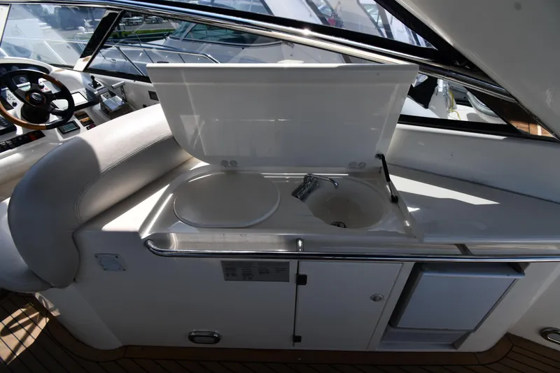 Slide: The Image of Interior view of 1997 Sunseeker Camargue 51 yacht, featuring a compact kitchenette area. - 24