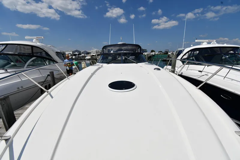 Slide: The Image of 1997 Sunseeker Camargue 51 yacht docked at marina under blue sky. - 9