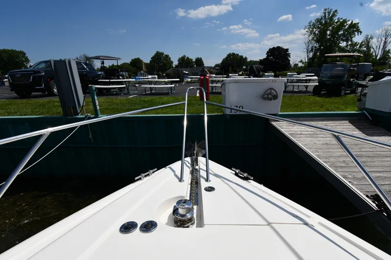 Slide: The Image of Bow view of 1997 Sunseeker Camargue 51 docked at marina under clear skies. - 7