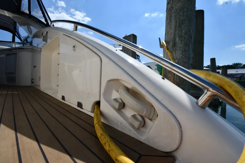 Slide: The Image of Sunseeker Camargue 51 yacht deck, 1997 model, featuring sleek design and wooden flooring. - 25