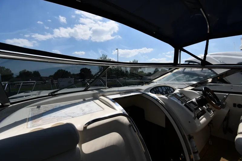 Slide: The Image of Interior view of 1997 Sunseeker Camargue 51 yacht cockpit under a clear blue sky. - 12