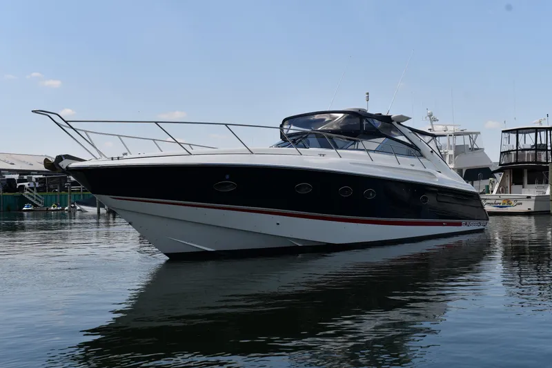 Slide: The Image of 1997 Sunseeker Camargue 51 yacht docked in a marina, reflecting on calm water. - 3
