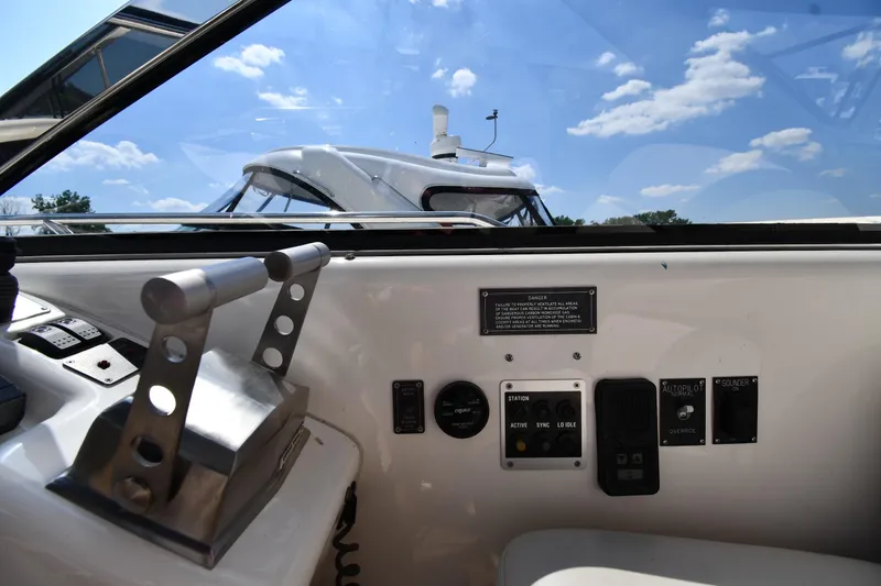 Slide: The Image of 1997 Sunseeker Camargue 51 yacht cockpit with controls and clear sky view. - 17