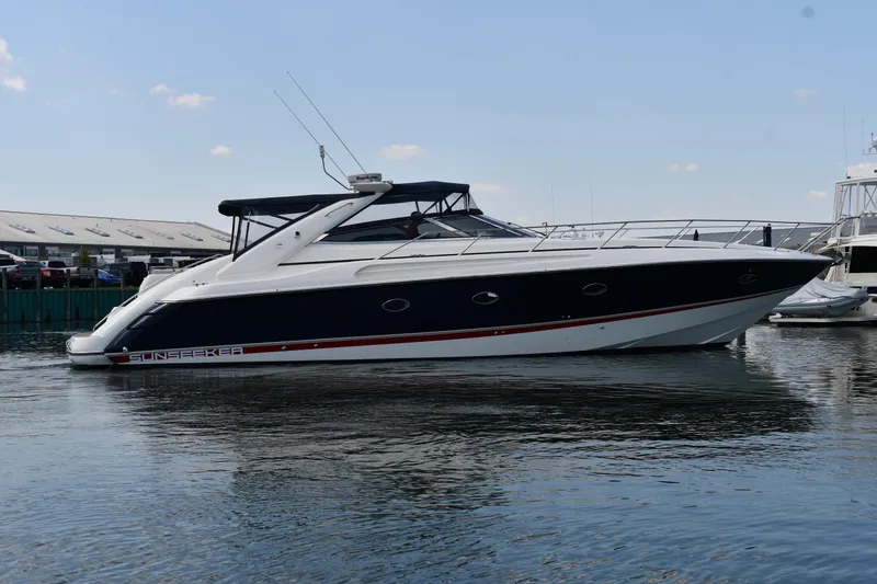 Slide: The Image of 1997 Sunseeker Camargue 51 yacht on calm water, side view. - 2