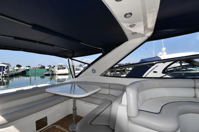 Slide: The Image of Luxurious Sunseeker Camargue 51 yacht interior with seating and table, docked at marina. - 21