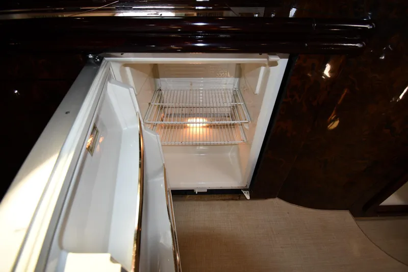Slide: The Image of Open refrigerator inside 1997 Sunseeker Camargue 51 yacht, showcasing interior shelving. - 56