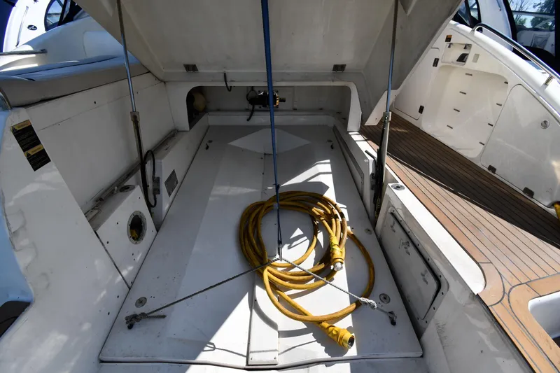 Slide: The Image of Open storage compartment on 1997 Sunseeker Camargue 51 yacht with yellow cable. - 58