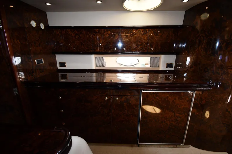 Slide: The Image of Luxurious wood-paneled interior of 1997 Sunseeker Camargue 51 yacht, featuring elegant cabinetry. - 51