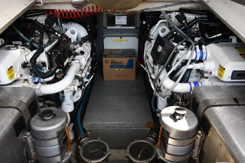 Slide: The Image of Engine room of a 1997 Sunseeker Camargue 51 yacht, showcasing dual engines and mechanical components. - 60