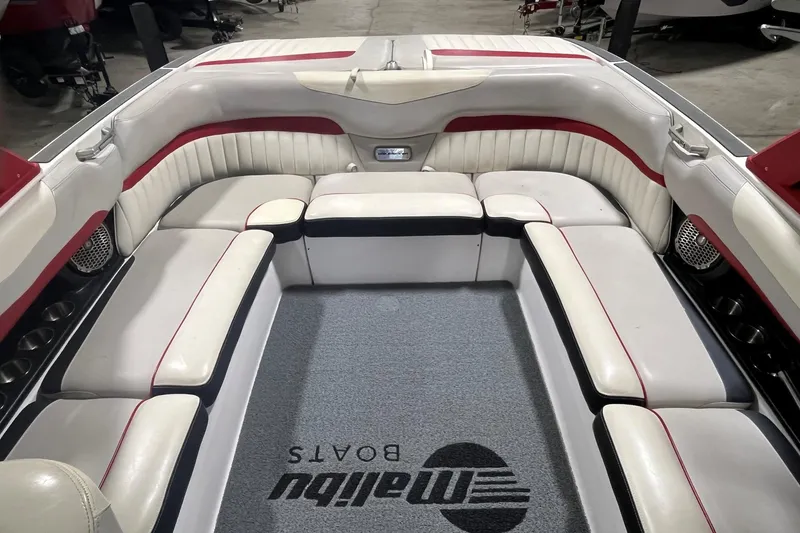 Slide: The Image of Interior of a 2015 Malibu Wakesetter 24 MXZ boat with white and red seating. - 8