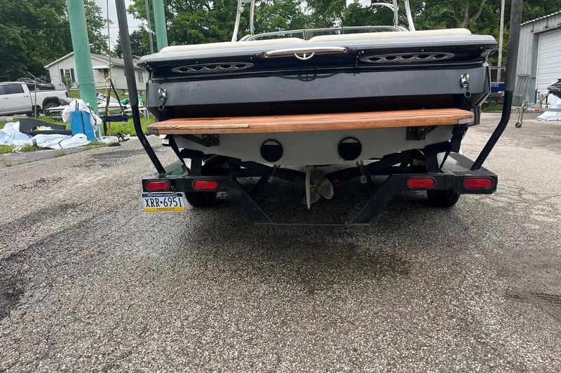 Slide: The Image of Rear view of a 2004 MasterCraft X-9 boat on a trailer in a driveway. - 4