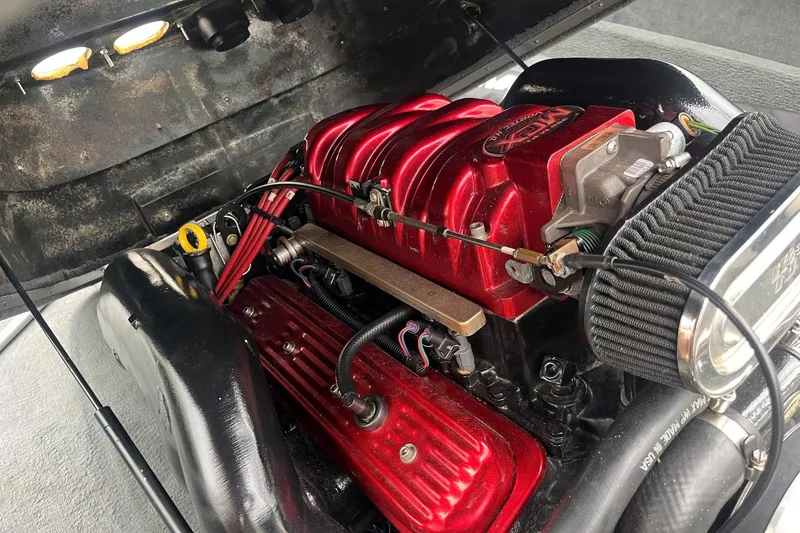 Slide: The Image of Engine of a 2004 MasterCraft X-9 boat with red components and air filter. - 12