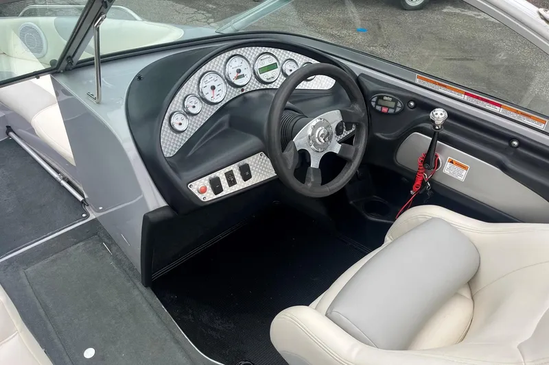 Slide: The Image of 2004 MasterCraft X-9 boat interior with steering wheel, gauges, and seating. - 13