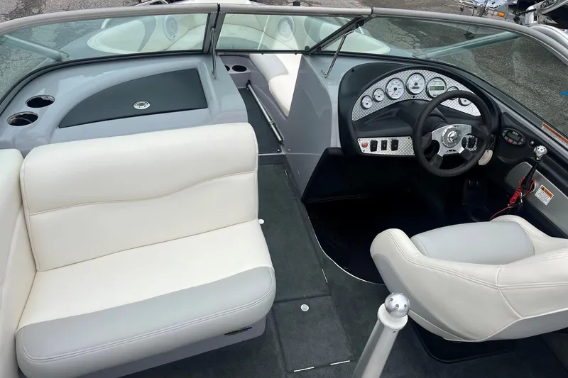 Slide: The Image of 2004 MasterCraft X-9 boat interior with steering wheel, dashboard, and seating. - 10
