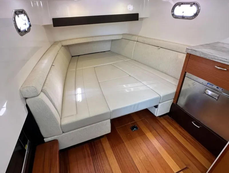 Slide: The Image of Interior of the 2017 Pursuit S 408 Sport with beige sofa and wooden floor. - 5