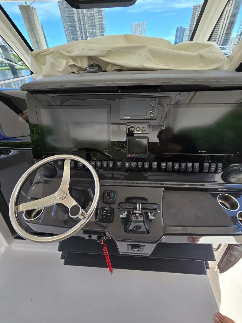 Slide: The Image of The cockpit of a 2017 Pursuit S 408 Sport with modern controls and screens. - 8