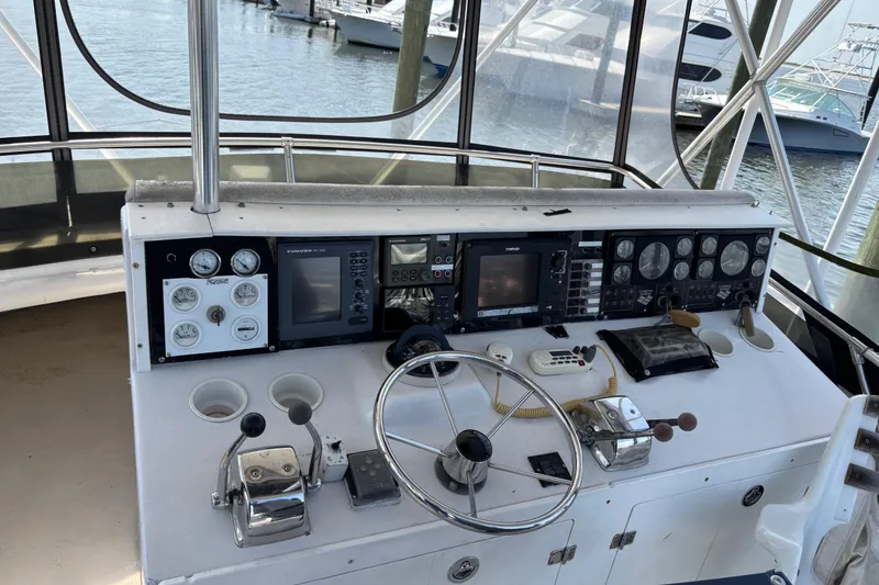 Slide: The Image of 1979 Trojan F-36 Convertible boat helm with gauges, steering wheel, and navigation equipment. - 8