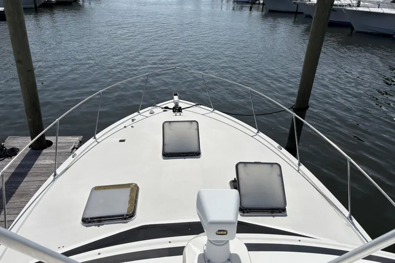 Slide: The Image of 1979 Trojan F-36 Convertible boat docked at marina, view from bow. - 7