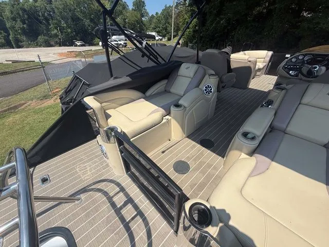 Slide: The Image of The image shows the deck of a 2017 Starcraft MX 23 C with beige seating and a helm station. - 21