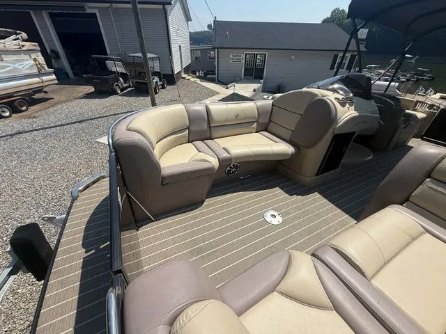 Slide: The Image of The image shows the interior of a 2017 Starcraft MX 23 C boat with beige seating. - 15