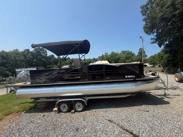 The Image of 2017 Starcraft MX 23 C pontoon boat on a trailer. - 1
