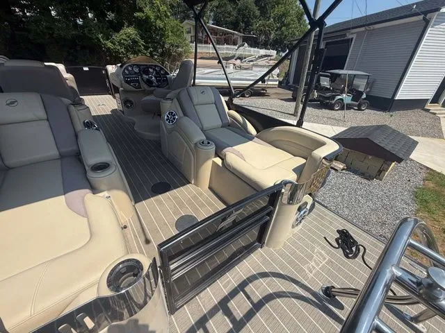 Slide: The Image of The image shows the interior of a 2017 Starcraft MX 23 C boat with beige seating. - 9