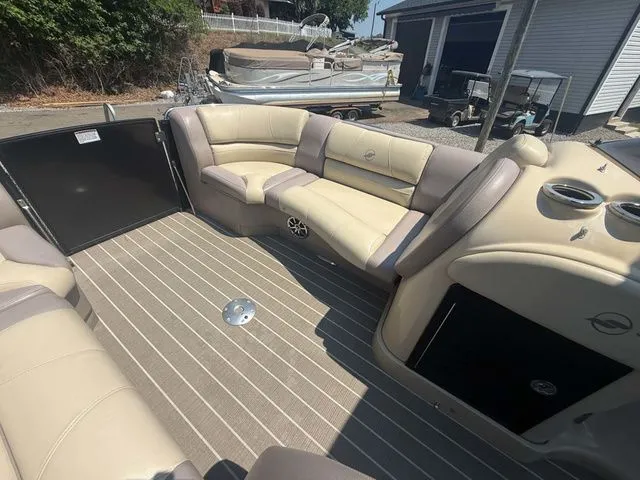 Slide: The Image of The image shows the interior of a 2017 Starcraft MX 23 C boat with beige seating. - 11