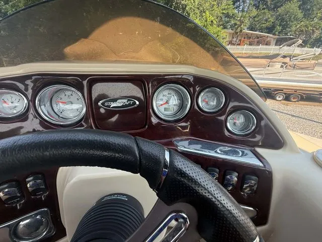 Slide: The Image of The dashboard of a 2017 Starcraft MX 23 C with multiple gauges and a steering wheel. - 18