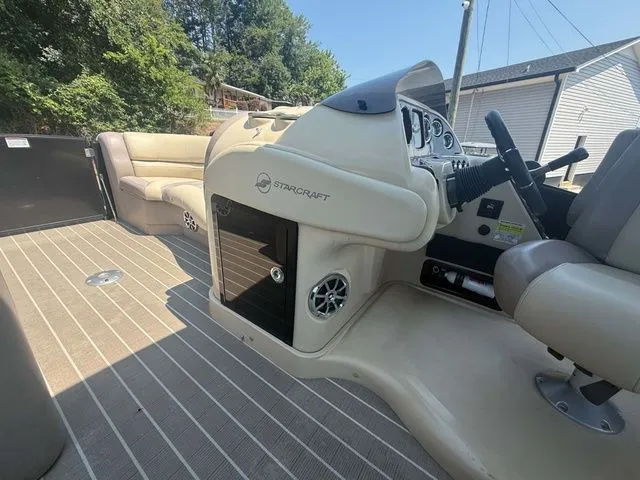 Slide: The Image of The image shows the cockpit of a 2017 Starcraft MX 23 C with beige seating. - 17