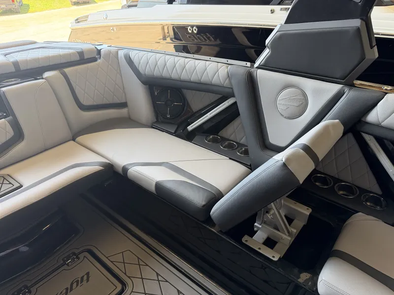 Slide: The Image of Interior of a 2021 Tigé 23ZX with gray and black upholstery and speakers. - 24