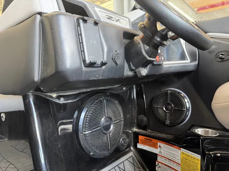 Slide: The Image of The image shows the dashboard of a Tigé 23ZX boat with speakers and controls. - 48