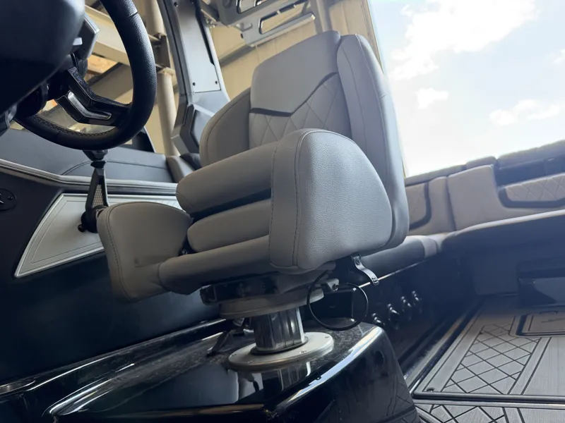 Slide: The Image of Interior of a 2021 Tigé 23ZX featuring a cushioned captain's chair and modern design. - 29