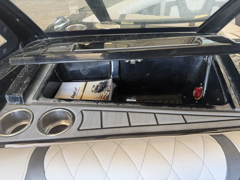 Slide: The Image of Interior view of a 2021 Tigé 23ZX with storage compartment and cup holders. - 41