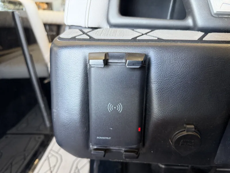 Slide: The Image of Close-up of a charging station in a 2021 Tigé 23ZX boat. - 33