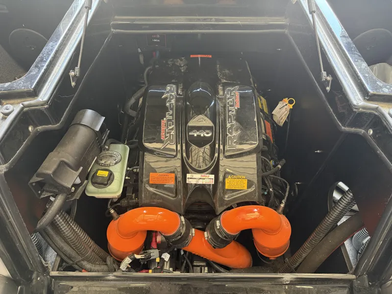 Slide: The Image of Engine compartment of a 2021 Tigé 23ZX with distinctive orange hoses and a robust engine. - 46