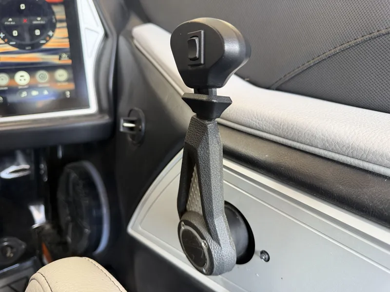 Slide: The Image of Close-up of a control lever in a boat, next to a screen with controls. - 36