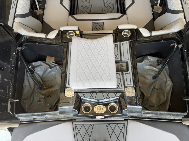 Slide: The Image of Interior view of a 2021 Tigé 23ZX with white upholstery and storage compartments. - 17
