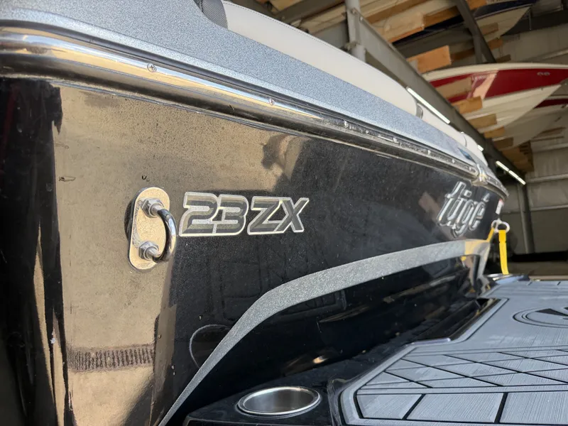 Slide: The Image of Close-up of the Tigé 23ZX boat hull in a storage facility. - 14