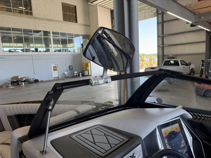 Slide: The Image of The image shows the cockpit of a 2021 Tigé 23ZX boat in a warehouse. - 37