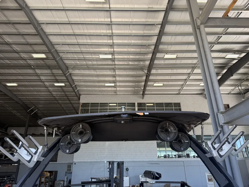 Slide: The Image of A 2021 Tigé 23ZX boat in a warehouse, featuring speakers and wakeboard racks. - 43