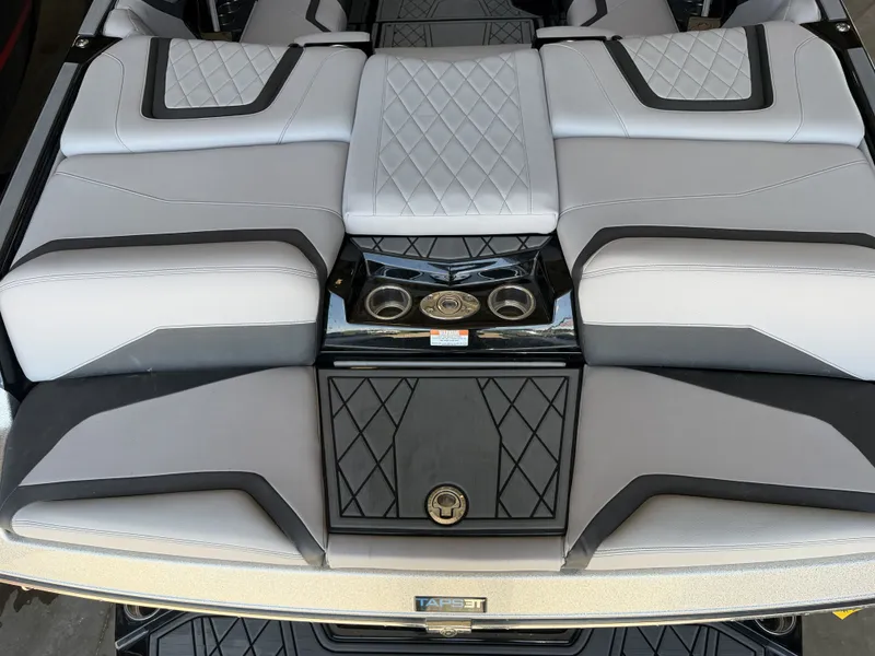 Slide: The Image of The image shows the luxurious stern of a 2021 Tigé 23ZX boat with sleek upholstery. - 15